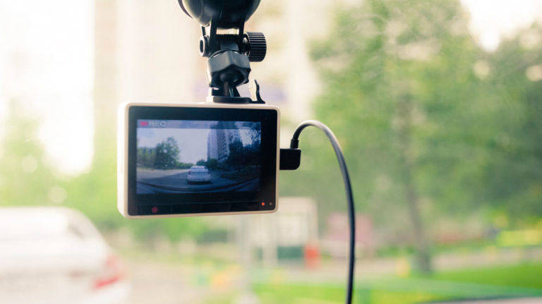 Dashcam recording footage of a road from within a vehicle.