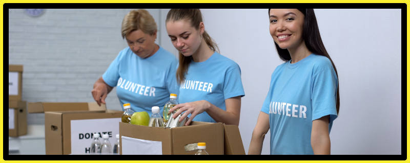 Group of not-for-profit volunteers pack donations into boxes.